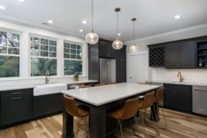 Open-concept kitchen showcase detailing glass globe pendant lighting hanging over a large dark wood island.